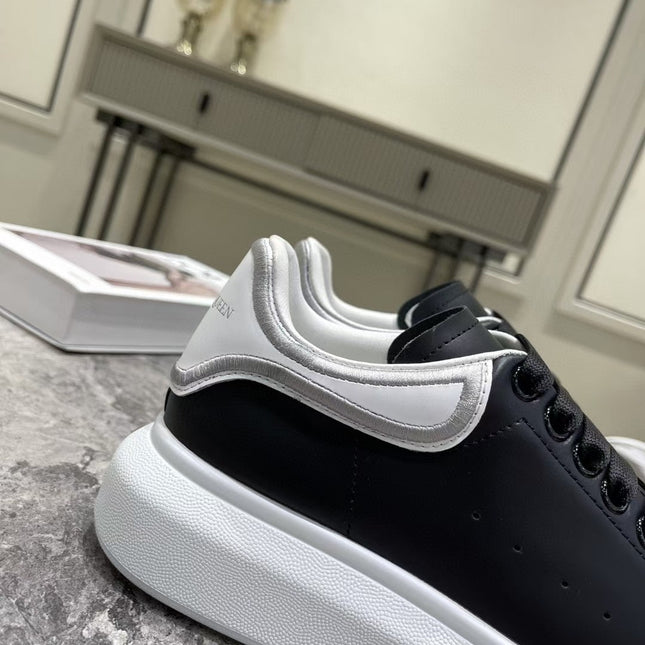 OVERSIZED SNEAKER IN BLACK CALFSKIN WITH SILVER STITCHED WHITE HEEL TAB