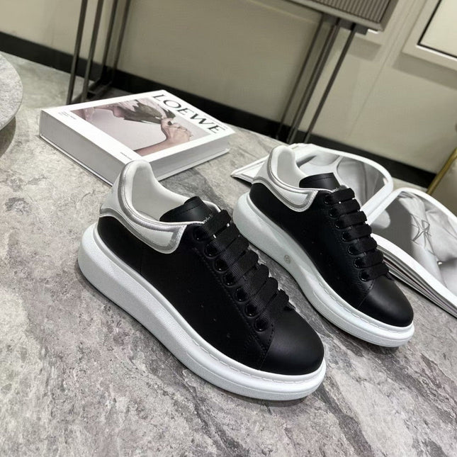 OVERSIZED SNEAKER IN BLACK CALFSKIN WITH SILVER STITCHED WHITE HEEL TAB