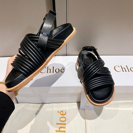 CROSS STRAP SANDAL IN BLACK RUBBER WITH GOLD HARDWARE