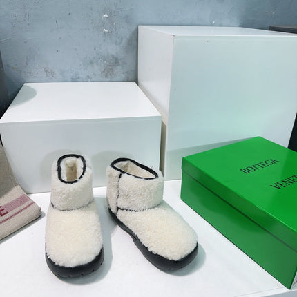 MINI ANKLE BOOT IN WHITE SHEARLING WITH BLACK ULTRA LIGHTWEIGHT RUBBER OUTSOLE