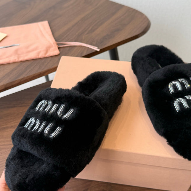 MIUMIU 26S CRYSTAL LOGO SLIDES IN BLACK SHEARLING