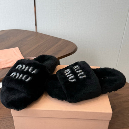 MIUMIU 26S CRYSTAL LOGO SLIDES IN BLACK SHEARLING