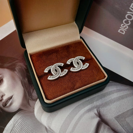 DOUBLE C STUD EARRINGS WITH WHITE TRIM AND CLEAR STONE LOGO