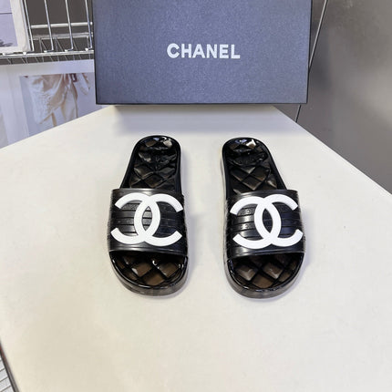 CHANEL 26S SLIDES IN BLACK PVC WITH WHITE LOGO