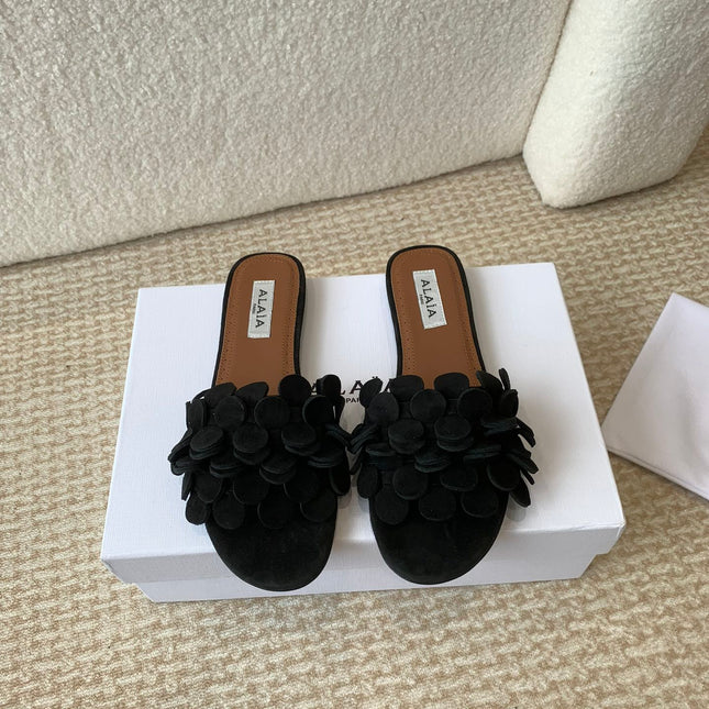 ALAIA FLAT MULE IN BLACK SUEDE