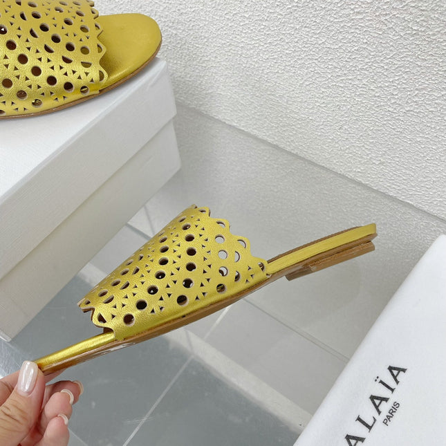 ALAIA VIENNE FLAT MULES IN GOLDEN LAMBSKIN