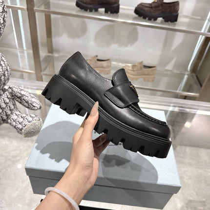 PRADA 25S THICK-SOLE LOAFERS 60 MM IN BLACK SMOOTH CALFSKIN
